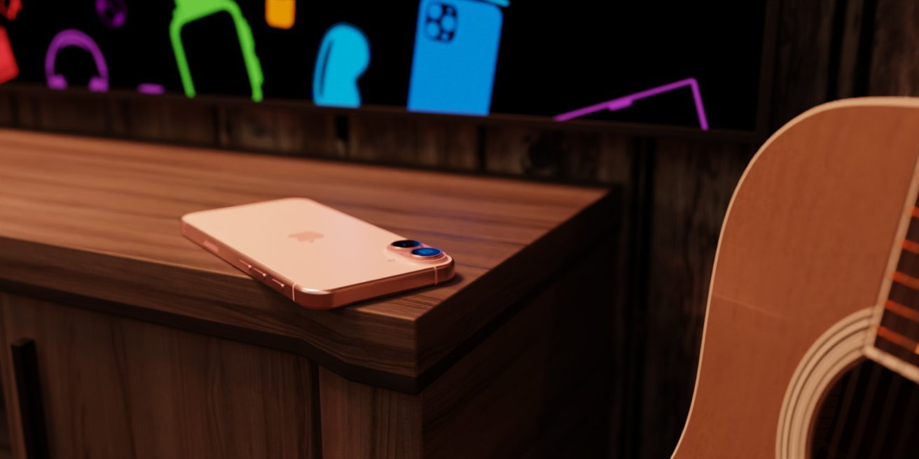 Rose gold smartphone on a wooden surface beside an acoustic guitar, colorful shapes on a screen in the background.