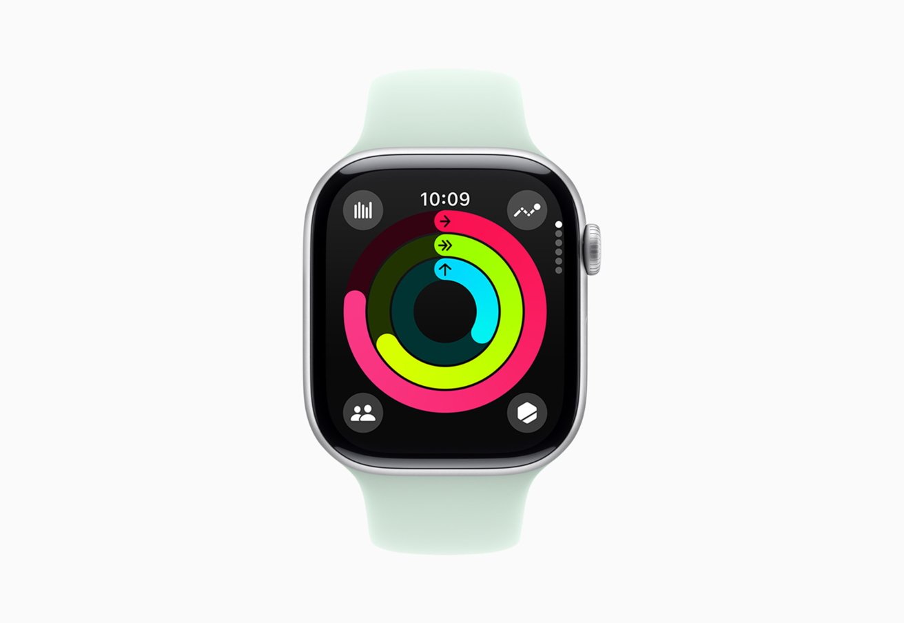 Apple Watch with a light green band displaying colorful activity rings on a black screen with a time of 10:09.
