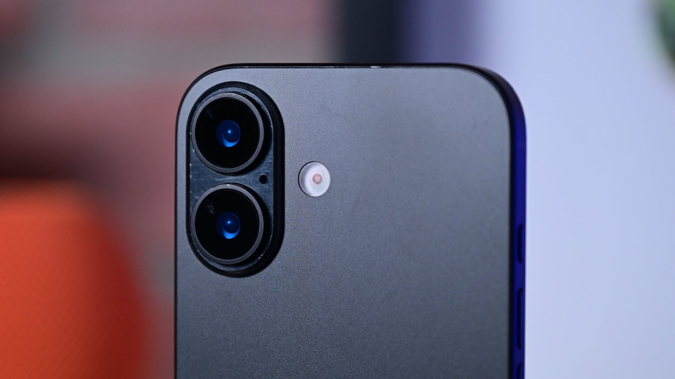 Close-up of a smartphone's dual rear cameras and flash on a sleek, metallic surface background.